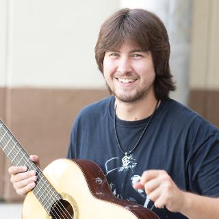 student playing a guitar